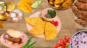 A image of a plate of 3 Jamaican Patties surrounded by various other food items available on our menu.